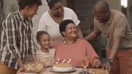 Family Celebrates Birthday Together with Cake and Joy