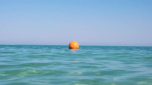 Yellow Buoy Floating on Sea Surface As Marker for Swimming Restriction in Deep Water at Tropical