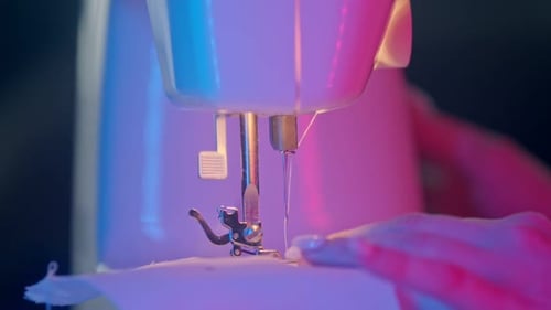 Sewing Machine Close Up with Fabric and Hands