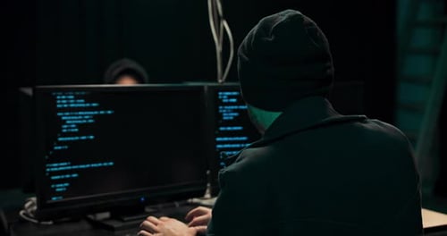 People Coding in a Dark Office at Night