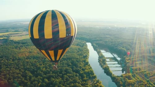 Hot Air Ballooning Over Scenic River Valley
