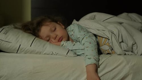 Child Sound Asleep in Bed at Night