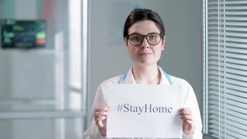 Doctor Holding Sign for Staying Home During Pandemic