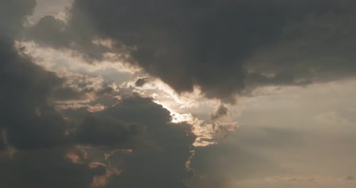 Sunlight Gleaming Through Clouds in a Dramatic Sky