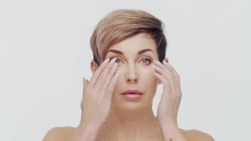 Close-up of middle aged mature woman over white background.