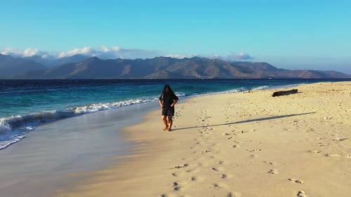 Modern fun woman relaxing spending quality time on beach on clean white sand and blue background 4K