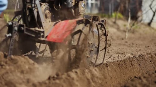 Tilling Soil with a Rotary Tiller in Field