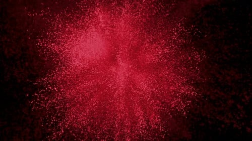 Red Powder Explosion Against Black Background