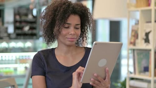 Woman Uses Tablet in Urban Indoor Setting