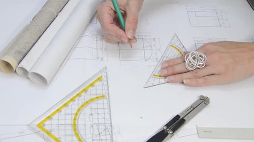 Architect Working on Blueprints in Office