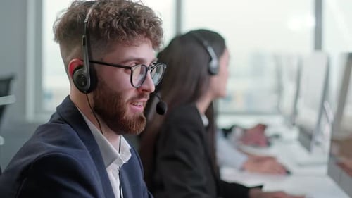 Call Center Agents Working at Desks in Modern Office