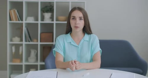 Woman Talking at Table in Home Interior