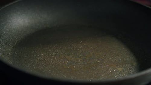 Frying Fresh Sardines in Oil on Pan