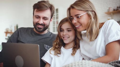 Family Watching Laptop Screen Together at Home