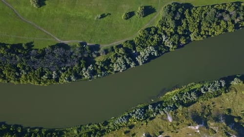 Aerial Video Drone Footage of a Large River Surrounded By Green Fields