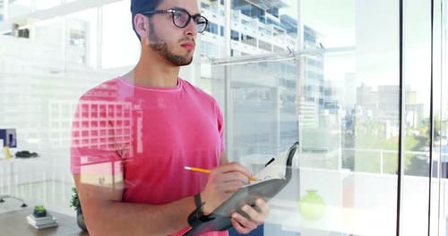 Male executive writing in organizer in the office 4k