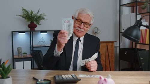 Senior Business Office Man Accountant or Banker Using Calculator Making Money Cash Calculations