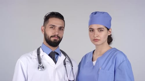 Cheerful Doctor and Nurse Smiling for Camera