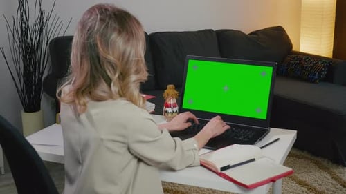 Woman Works on Laptop with Green Screen