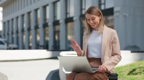 Woman on Video Call Working Outside Office Building