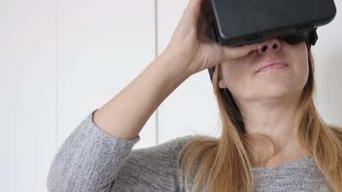 Woman Adjusting VR Headset in Bright Interior