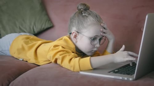 Blonde Girl Typing Something On A Laptop Computer