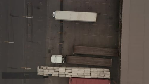 Birds Eye View of Cargo Truck Loading Area with Crates and Containers