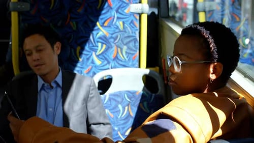 Man and Woman Commuting on a Bus