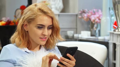 Woman Using Smartphone Indoors