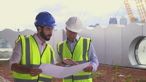 Architects Reviewing Plans on a Building Rooftop