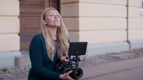 Woman Camera Operator Reviews Digital Camera Footage
