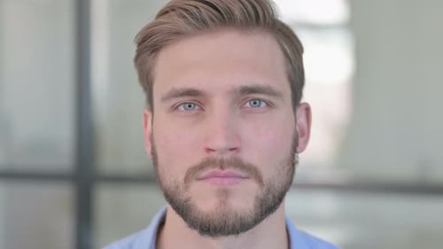 Close Up of Face of Serious Creative Man Looking at Camera