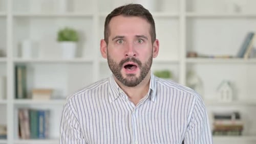 Bearded Man Reacting with Surprise, Hand Over Mouth
