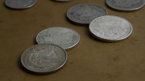 Close up of Silver Coins on Brown Surface