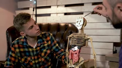 Middle Close Up of Young Boy Listening To Father Telling About the Structure of Human Body Organs