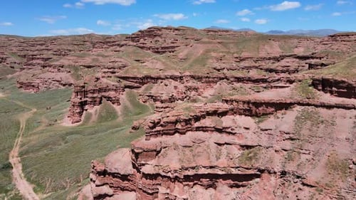 Aerial View of Layered Rock Formations in Desert Landscape