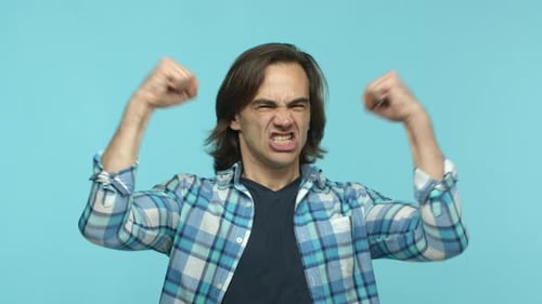 Adult Man Showing Anger with Raised Fists