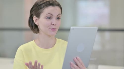 Woman Video Calling on Tablet Device Indoors