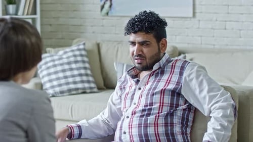 Man Talking on Couch During Counseling Session