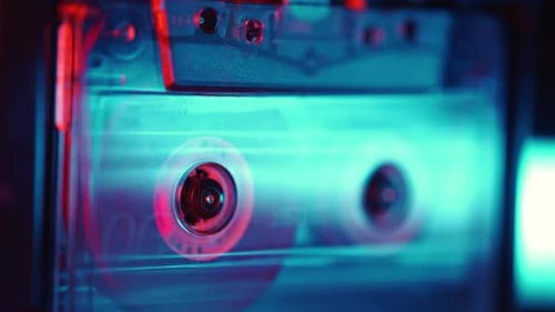 Close Up of Cassette Tape Spinning with Retro Colors