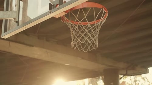 Basketball Player Scores a Dunk on a Basketball Hoop