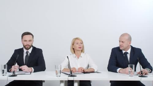 Panel of Adults Speaking at Corporate Meeting