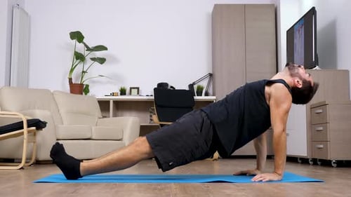 Man Doing Core Workout Dynamic Planks at Home