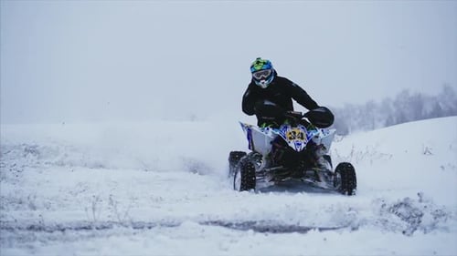 Person Riding ATV in Winter Snow