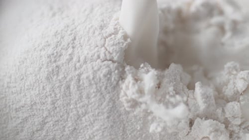 Milk Poured into White Baking Powder Close Up