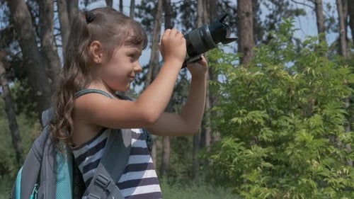 Girl Taking Photos with Camera in Forest