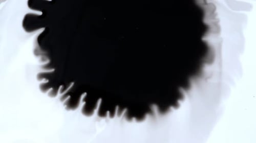 Abstract Black Ink Spreading on White Surface
