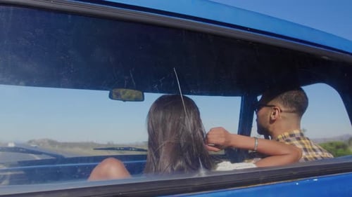 Young couple on a road trip in their pick-up truck