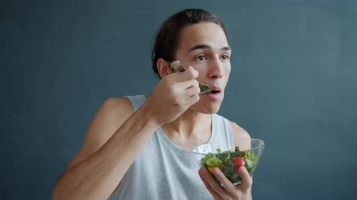 Young Adult Eating Healthy Salad