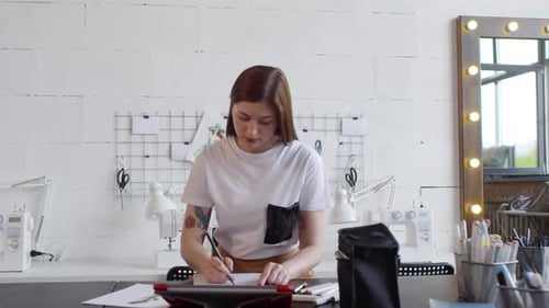 Fashion Designer Sketching in Creative Studio